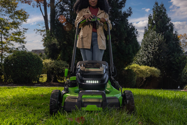 Woman using Greenworks lawn mower